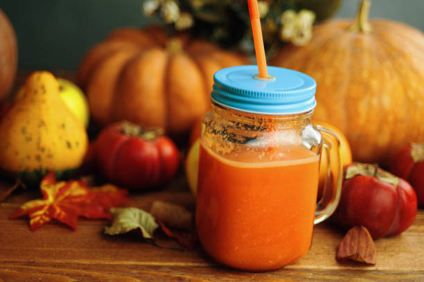 istock Pumpkins juice in bottles with pumpkins. 1220971908