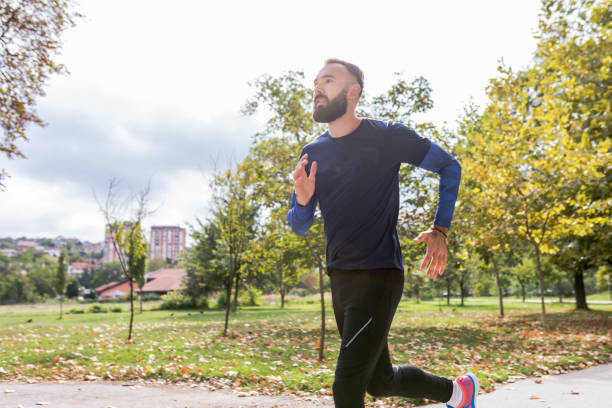 istock Professional athlete jogging in nature 1220972028