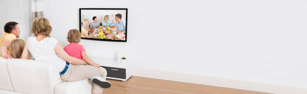 istock Young Family Watching TV Together 1220973369