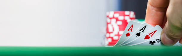 istock Poker player holding playing cards 1220973413