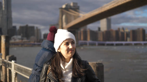 istock Two friends in New York take a walk at Brooklyn Bridge 1220973633