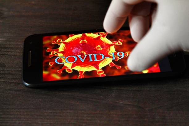istock Hand in surgical glove pointing at a mobile phone 1220974992