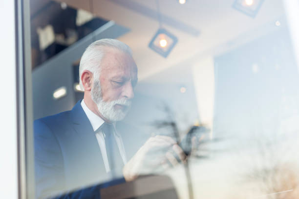 istock Senior businessman sending an email using smart phone 1220975024