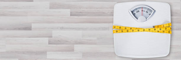 istock Weight Scale Wrapped In Measure Tape 1220975452