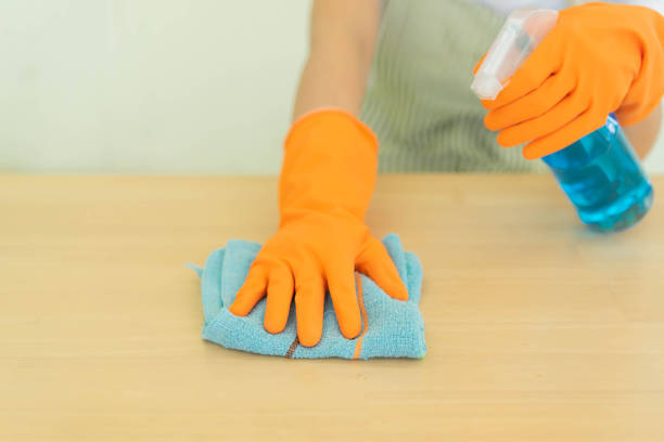 istock close up maid house keeper using microfiber fabric swipe to cleaning kitchen table in quarantine time concept 1220976970