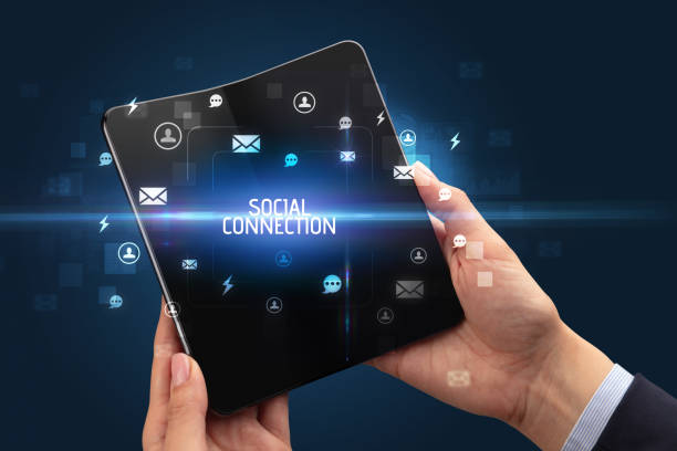 istock Businessman holding a foldable smartphone, social media concept 1220977360