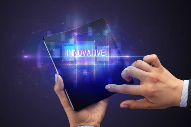 istock Businessman holding a foldable smartphone 1220979137