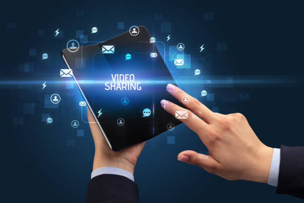 istock Businessman holding a foldable smartphone, social media concept 1220981421