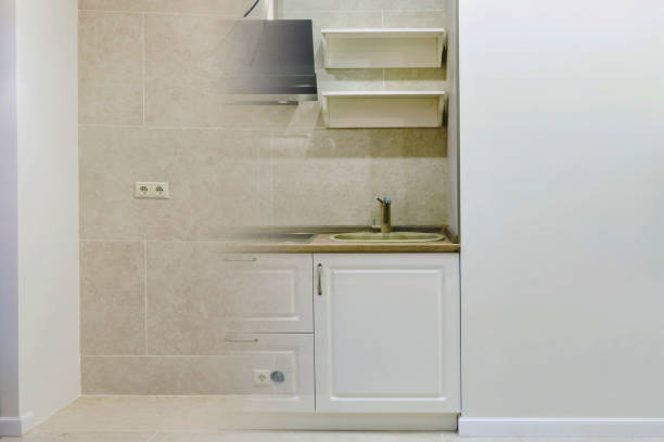 istock Kitchen before and after renovation, copy space for text. Modern small kitchen in the apartment before and after installing furniture 1220982765