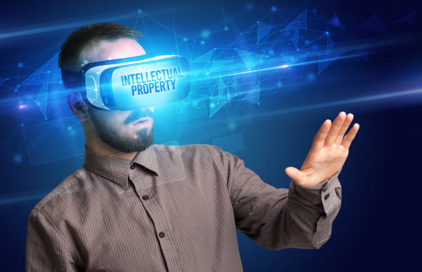 istock Businessman looking through Virtual Reality glasses, virtual security concept 1220983181