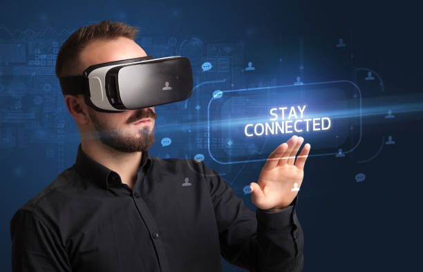 istock Businessman looking through Virtual Reality glasses, social media concept 1220983420
