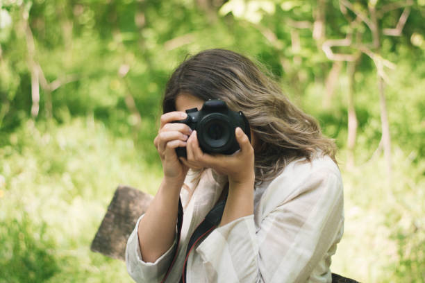 istock Nature adventure, beautiful woman with camera 1220983837