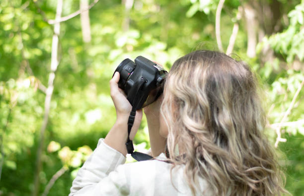 istock Nature adventure, beautiful woman with camera 1220983894
