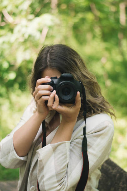 istock Nature adventure, beautiful woman with camera 1220983957