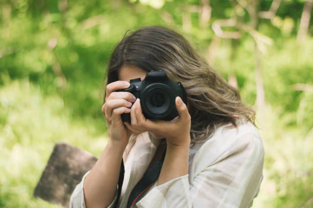istock Nature adventure, beautiful woman with camera 1220983972