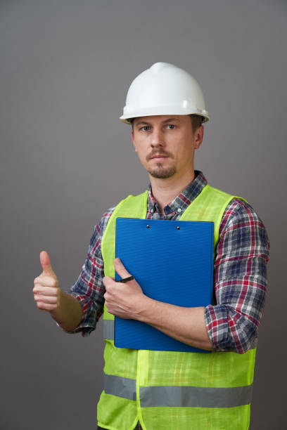 istock Worker man wearing protective hard hat and reflective vest. 1220984529