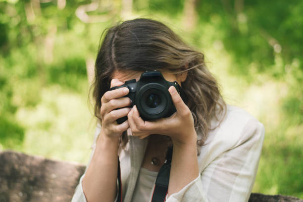 istock Nature adventure, beautiful woman with camera 1220984568