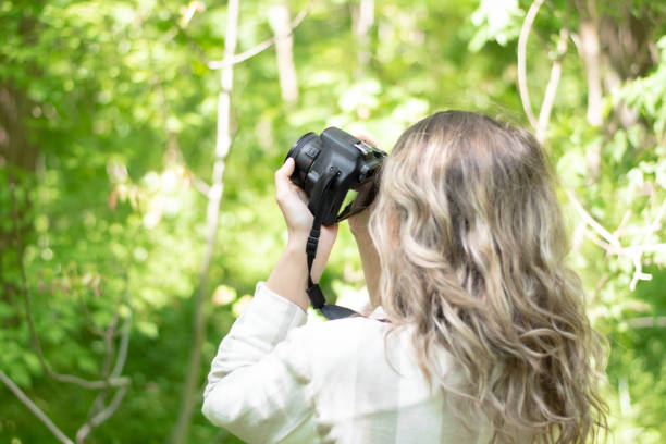istock Nature adventure, beautiful woman with camera 1220984593