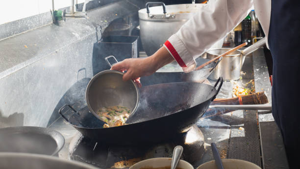 istock Chef stir fry in wok. 1220986895