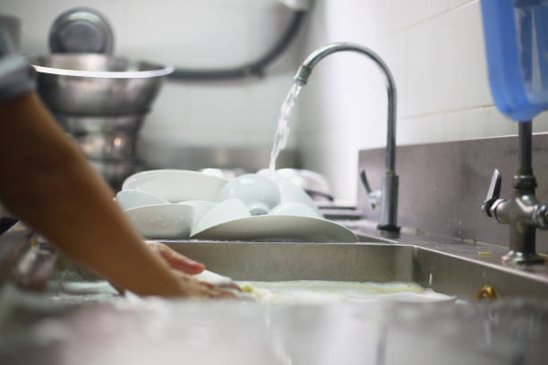 istock Woman washing dish 1220986971