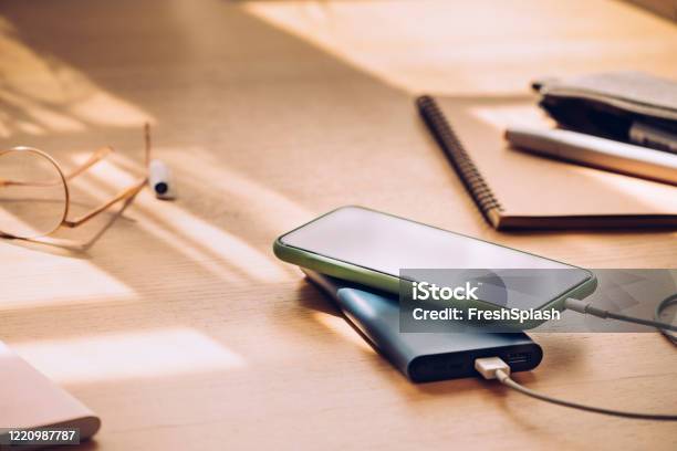 Mobile Phone Charging On A Portable Power Bank A Close Up Stock Photo - Download Image Now