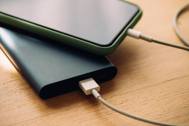 istock Mobile Phone Charging on a Portable Power Bank, a Close Up 1220987788