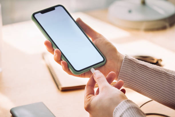 istock Close Up of an Anonymous Woman Using her Mobile Phone While it is Charging on a Portable Power Bank 1220987792
