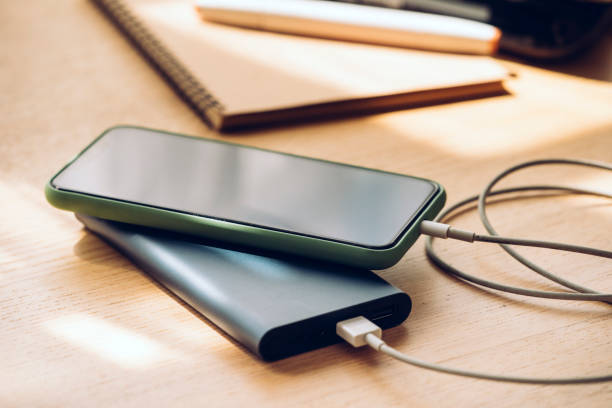 istock Mobile Phone Charging on a Portable Power Bank, a Close Up 1220987797