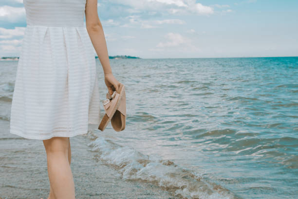 istock girl with beach slippers 1220987914
