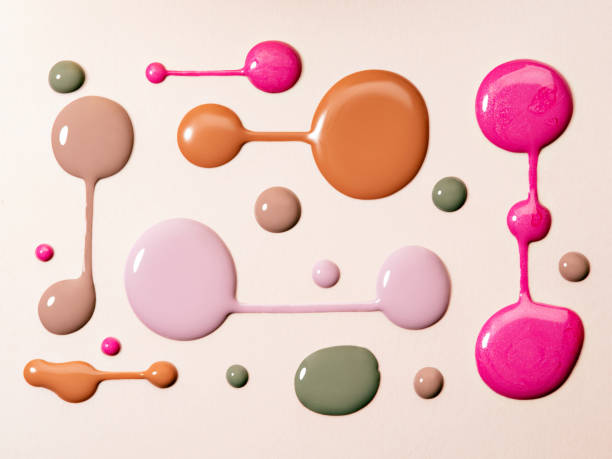 Round Blots of neutral coloured nail polish.