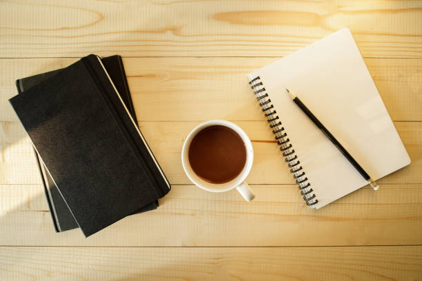 istock cup of hot chocolate on wooden background with notebook.  Work from home concept. 1220988891