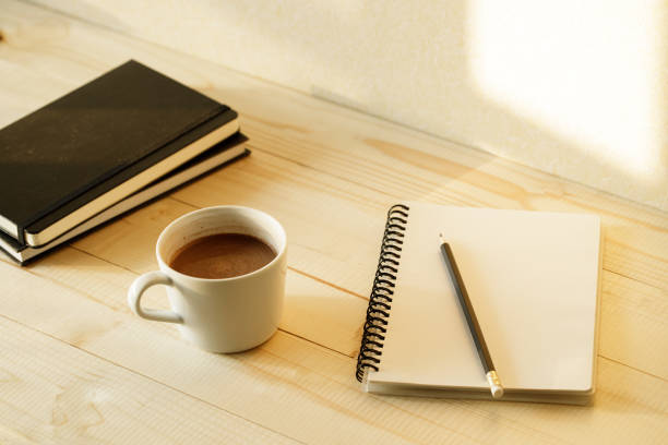 istock cup of hot chocolate on wooden background with notebook.  Work from home concept. 1220988894