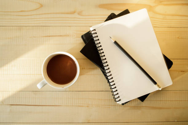 istock cup of hot chocolate on wooden background with notebook.  Work from home concept. 1220988905