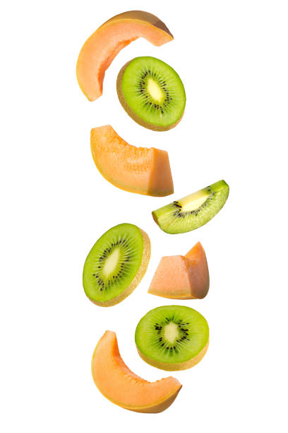 istock Falling kiwi and melon isolated on white background. 1220989264