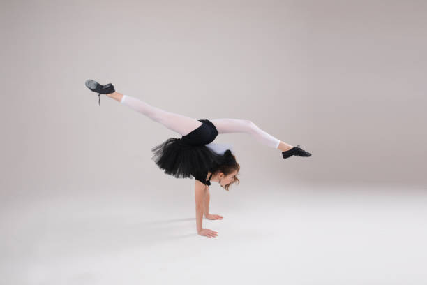 istock Pretty small girl doing gymnastics in studio 1220990136