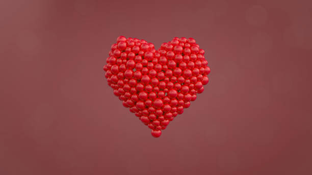 istock Red heart shape made out of shiny spheres. 1220991607