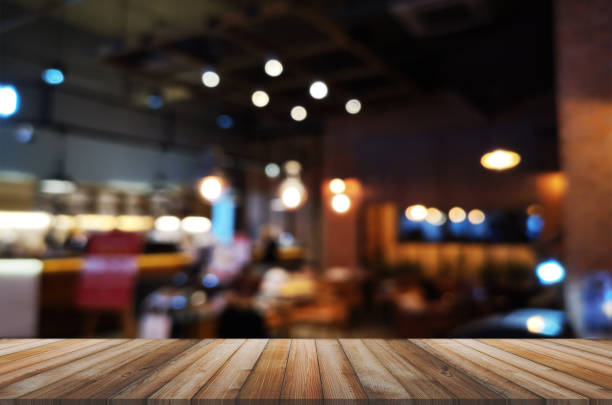 istock wooden table with abstract blurred background restaurant lights used for display montage products mock up design. 1220992115