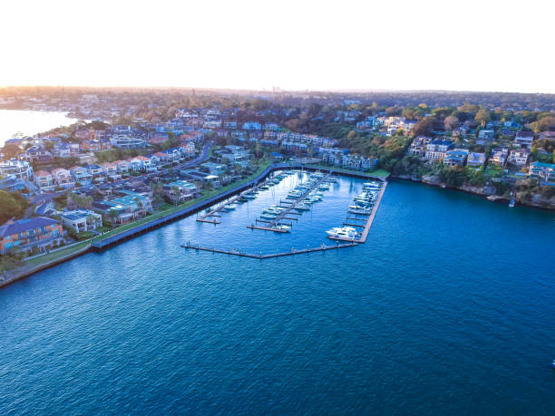 istock Panoramic drone aerial view over Sydney harbour on a cloudy sunset showing the nice colours of the harbour foreshore 1220993376