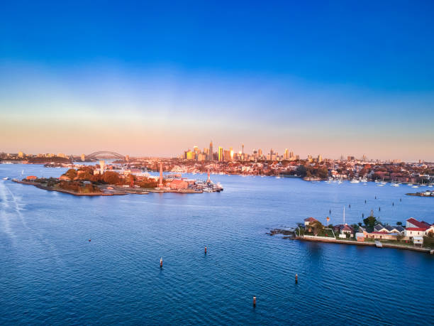 istock Panoramic drone aerial view over Sydney harbour on a cloudy sunset showing the nice colours of the harbour foreshore 1220993434