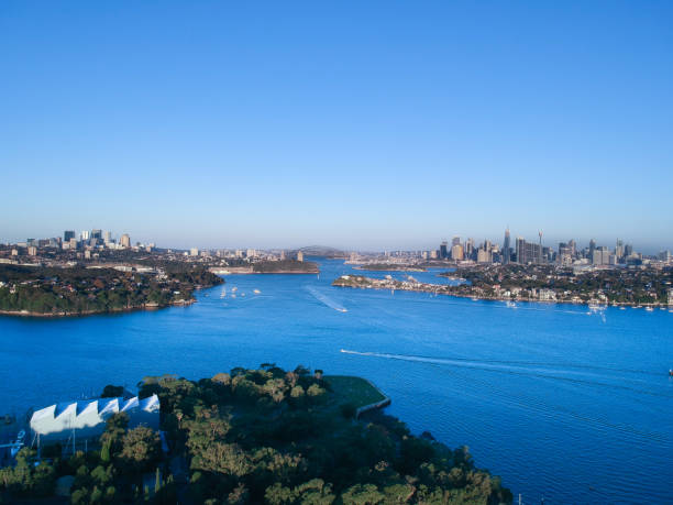 istock Panoramic drone aerial view over Sydney harbour on a cloudy sunset showing the nice colours of the harbour foreshore 1220993485