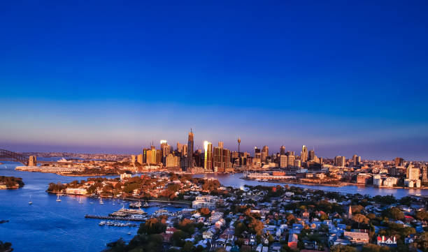 istock Panoramic drone aerial view over Sydney harbour on a cloudy sunset showing the nice colours of the harbour foreshore 1220993571