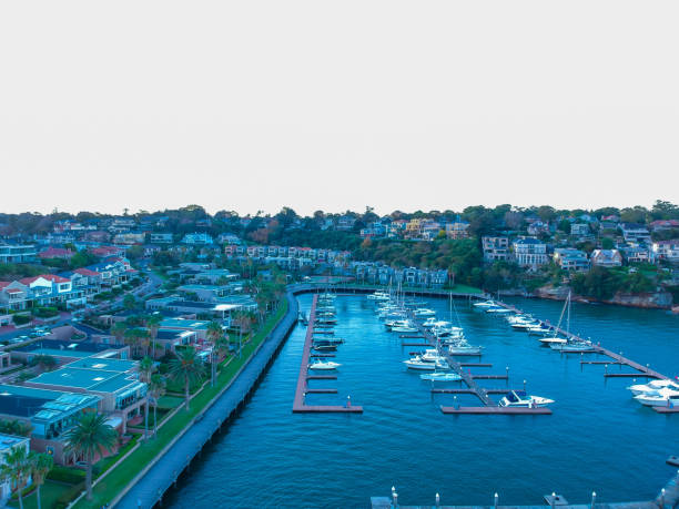 istock Panoramic drone aerial view over Sydney harbour on a cloudy sunset showing the nice colours of the harbour foreshore 1220993576