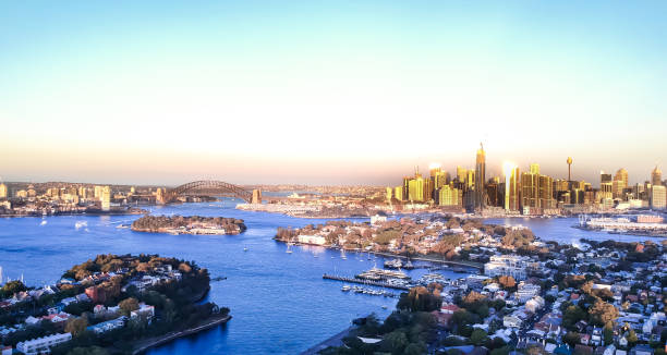 istock Panoramic drone aerial view over Sydney harbour on a cloudy sunset showing the nice colours of the harbour foreshore 1220993589