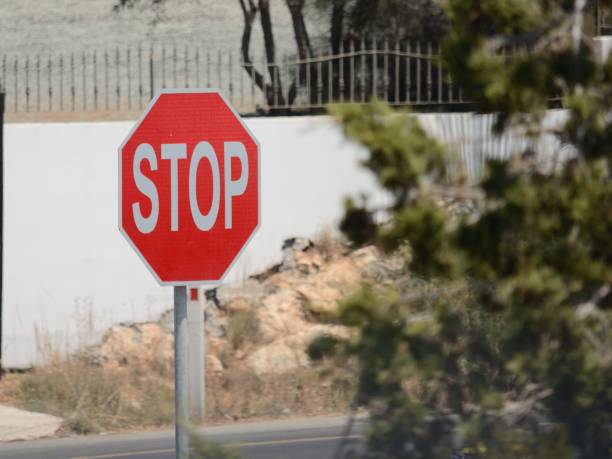 istock Road stop sign on the background foliage on the sides 1220993904