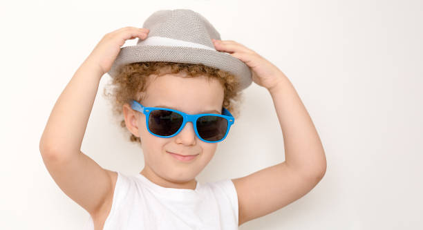 istock Happy boy in straw hat over white background 1220994044