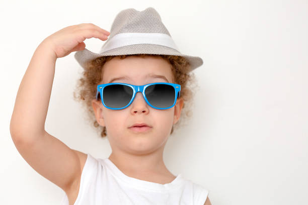 istock Happy boy in straw hat over white background 1220994361