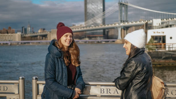 istock Two friends in New York take a walk at Brooklyn Bridge 1220995037