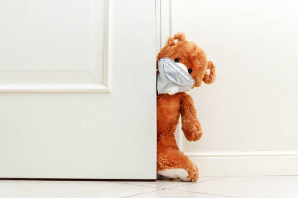 istock Teddy bear in mask stay at home in quarantine. 1220995414
