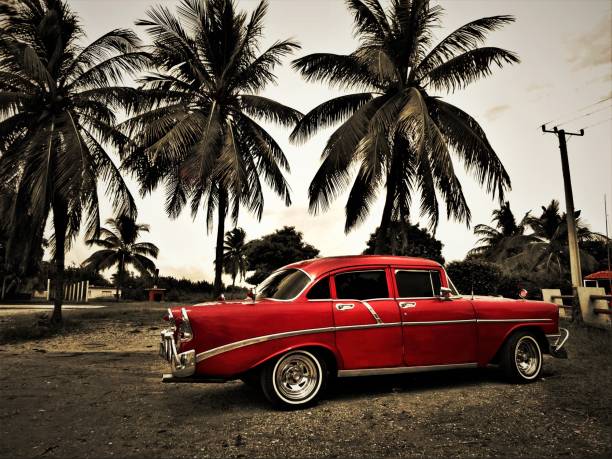 istock Old red classic cuban car and some palms 1220996991