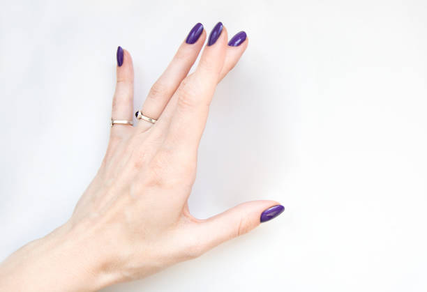 istock Graceful woman hand holding something on white background. 1220997558